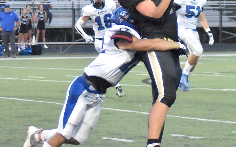 Gary Corsair • Clay County Progress Kyle Lunsford, No. 7 hauls in a pass near midfi eld just before dragging a Georgia Force defender for several yards.