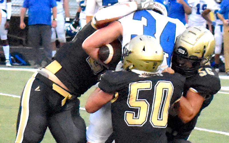 Gary Corsair • Clay County Progress Seth McCaslin, No. 50; Cameron Payne, No. 56 and Michael Mauney stop Georgia Force fullback Jordan Harrell, No. 34.