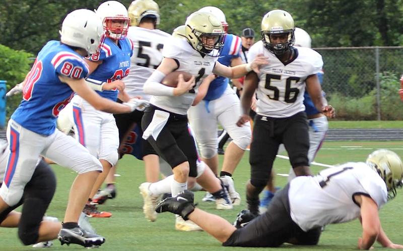 Kendra Coker • Photo Hayesville JV quarterback Peyton McGaha, 1, follows blockers Brendon Collins and Will Brown (56) up the middle for a big gain against Madison.