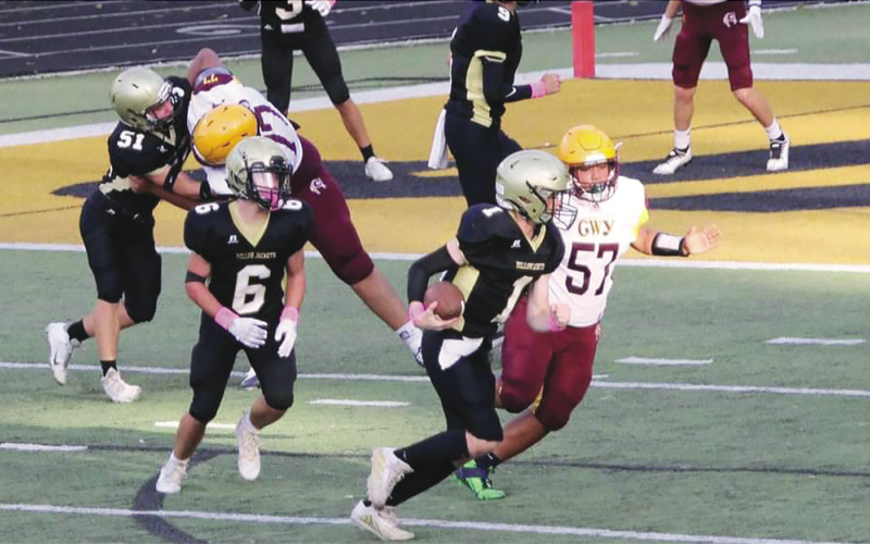 Photo •  Kendra Coker Hayesville JV quarterback Peyton McGaha, No. 1, heads for the endzone after faking a handoff to Tre Graves, No. 6, while E.J. Abrams, No. 51, blocks on the blind side.