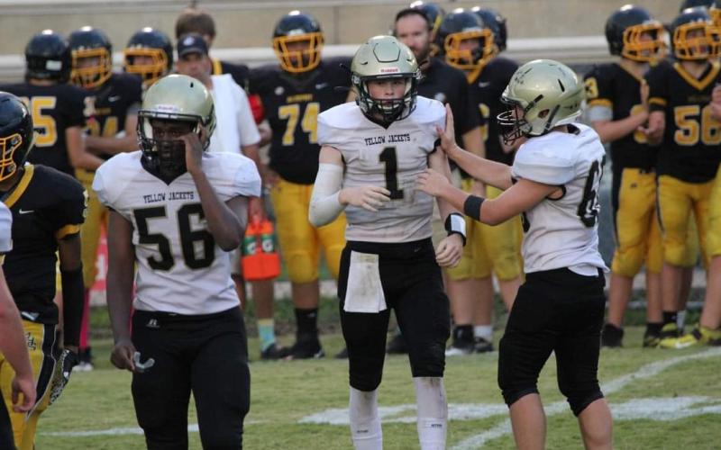 Photo • Kendra Coker Teammates Will Brown, No. 56, Peyton McGaha, No. 1 and Tre Graves, No. 6 are often referred to as the “Dynamo Three.”