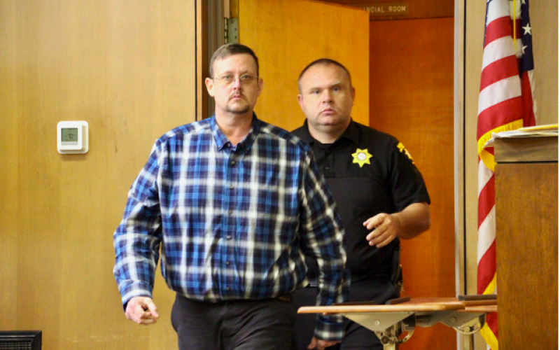 Photo • Shawn Jarrard Towns County Sheriff’s Capt. John McCoy escorting defendant Jason Matheson into the courtroom last week.