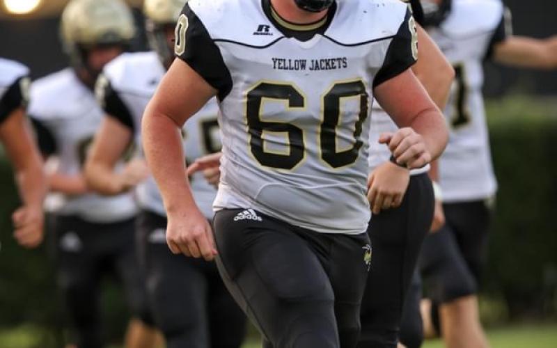 Photo • Asher Brown Lane O'Dell, No. 60, leads his teammates onto the field. Lane "The Train" also led the Yellow Jackets on the field of battle with outstanding blocking and bone-crunching tackling.