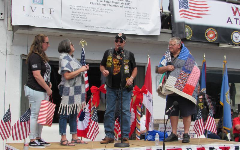 Photo by Linda Hagberg From left, VSO Danna Pash, Cherokee County Chamber Director Sherry Raines, Bruno Coltri and John Bandy are on stage as Raines is presented a Sisters Who Serve shawl and Bandy a Quilt of Valor.