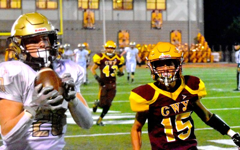 Gary Corsair • Clay Progress Hayesville’s Taylor “Hit-and-Run” McClure, No. 20, motors down the sideline on a pass reception after eluding Cherokee’s Tyler Wolfe, No. 15.