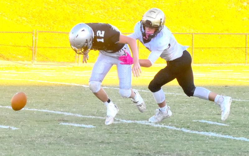 Gary Corsair •  Clay County Progress Robbinsville punt returner Tillman Adams coughs up the ball after being popped by Tre Graves. Will Brown recovered for Hayesville.