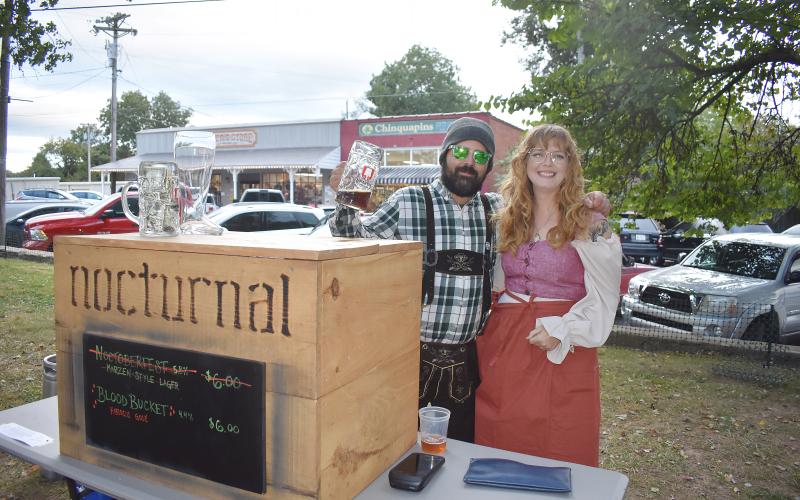 Becky Long • Clay County Progress David Grace and Emily Brown relax after a busy evening manning the Nocturnal booth during Steins &amp; Wine Around the Square.