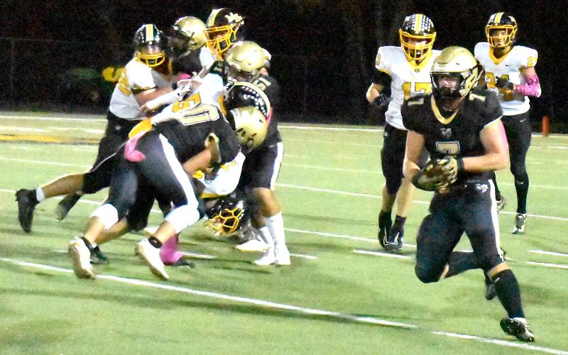 Gary Corsair • Clay County Progress Hayesville's Kyle Lunsford, No. 7, bolts for daylight after eluding two Murphy defenders.