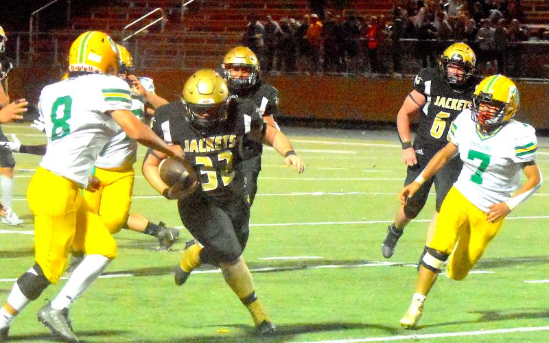 Gary Corsair • Clay County Progress  Yellow Jackets super sophomore Dawson “Freight Train” DeVane busts through a huge hole in the second half of Hayesville’s 37-22 playoff victory over Alleghany.