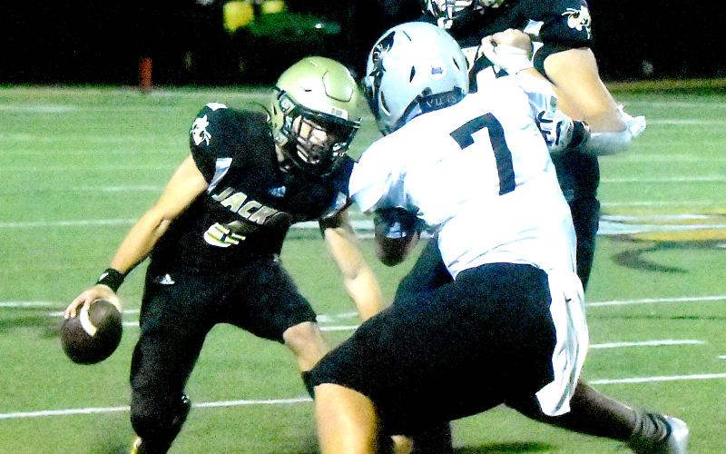 Gary Corsair • Clay County Progress Hayesville's Scramblin' Man Logan Caldwell, No. 6, goes crazy legs on his way to a big gainer as Zek Furby, No. 71, bulldozes Black Knight Turner Jackson, No. 7.