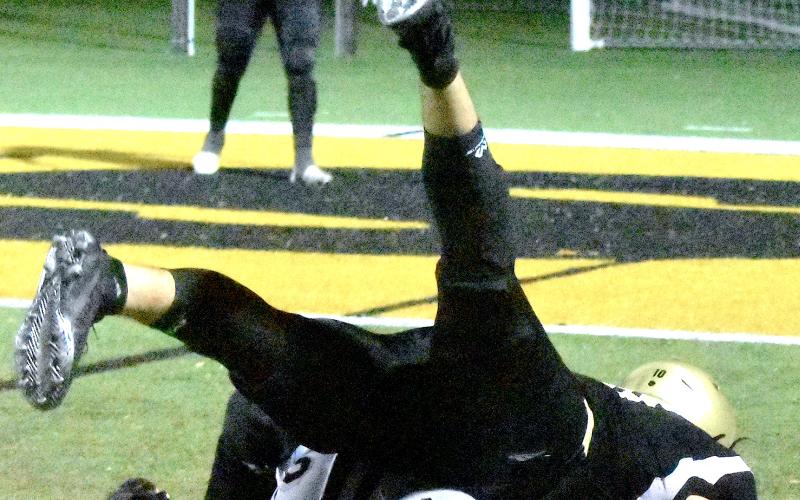 Gary Corsair • Clay County Progress Hayesville's Avery Leatherwood, No. 10, hangs onto the football after being upended by a Robbinsville defender after Avery caught a pass and charged toward the end zone where teammate Taylor McClure, No. 20, awaited after running a pass route. Leatherwood's catch set up Hayesville's first score — Yellow Jackets linebacker Kyle Lunsford, No. 7, fills Bryce Adams’ dance card during Robbinsville’s 21-9 victory Friday. a field goal by Isaac Chandler.