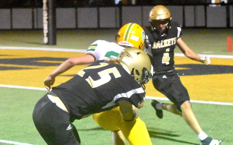 Gary Corsair • Clay County Progress  Bryan Davenport, No. 25, and Isaac Chandler, No. 4, stop Alleghany’s Mac Lemasters short of the goal line.