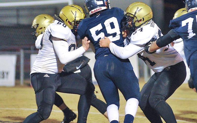 Zach Colburn • The Mount Airy News Hayesville linemen Lane O'Dell, No. 50, and Nathan Dockery, 54, sandwich Mount Airy’s Camron Webster.