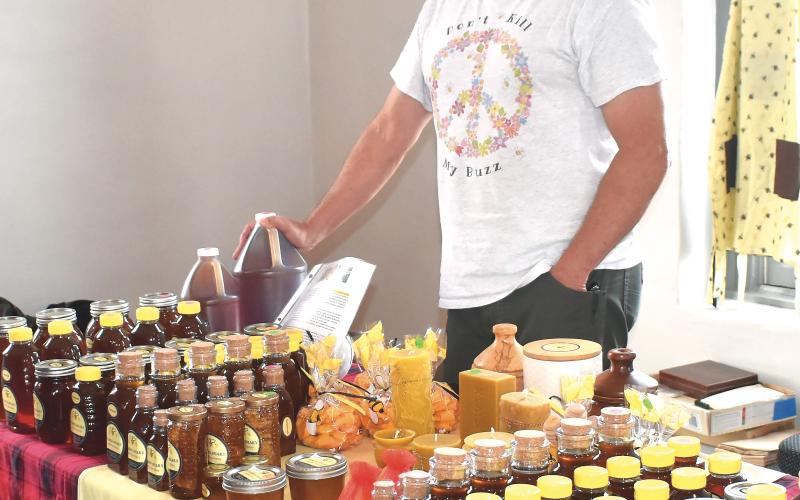 Becky Long • Clay County Progress Jim Crabtree mans the “G’s Bees Apiary booth during Friday’s Made in the Mountains market at the Beal Center.