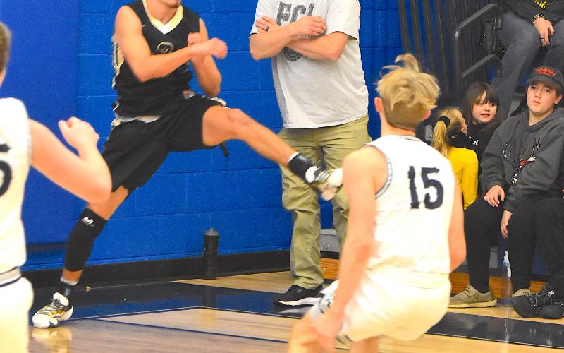 Gary Corsair • Clay County Progress Logan Caldwell, No. 2, does a balancing act on the baseline as he saves the ball from going out of bounds for Hayesville Tuesday at Nantahala. Caldwell had another big night, leading the Yellow Jackets with 21 points even though he sat out the entire fourth quarter.