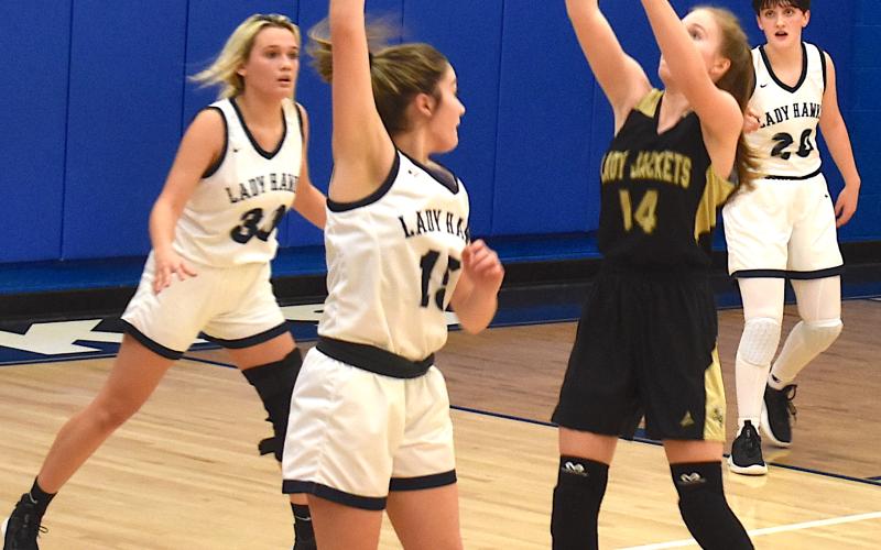 Gary Corsair • Progress Hayesville's Briley Clampitt reaches for a pass from Emma Ashe as Nantahala's defense closes in.