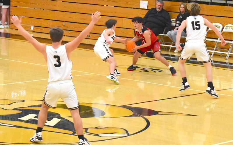 Gary Corsair • Clay County Progress Yellow Jackets E.J. Abrams, No. 3, Cooper Matheson, No. 2 and Kyle Shaheen, No. 15, trap Andrews near half court during the frantic final minute of Saturday's JV game. Hayesville fought valiantly and nearly engineered a comeback but fell to the Wildcats.