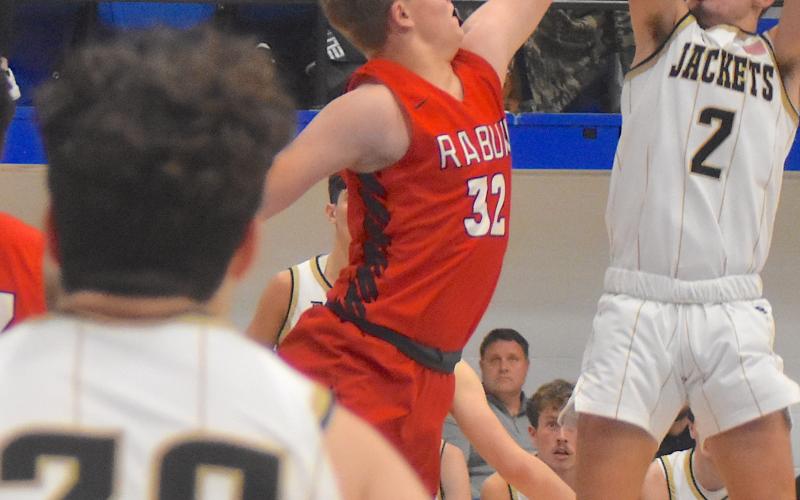 Gary Corsair • Clay County Progress Hayesville's Logan Caldwell, No. 2, lights up Polk County with a midrange jump shot. Caldwell's outstanding play in all three games earned him All-Tournament Team honors.