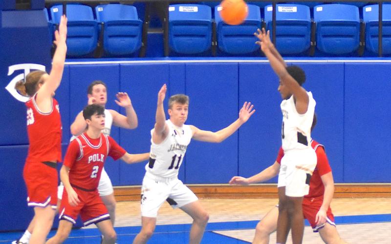 Gary Corsair • Clay County Progress Is it a jump shot or a pass? That's what Polk County defenders wonder as Hayesville's Asher Brown, No. 10, gets off the floor to deliver a slick pass to Kyle Lunsford, No. 33, as teammate Isaac Chandler, No. 11, cuts through the lane.