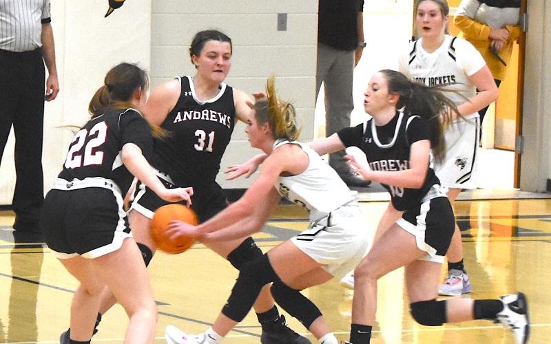 Gary Corsair • Clay County Progress  Hayesville's Ava Shook slips a pass through three Andrews defenders during the Lady Yellow Jackets Smoky Mountain Conference victory on Saturday.