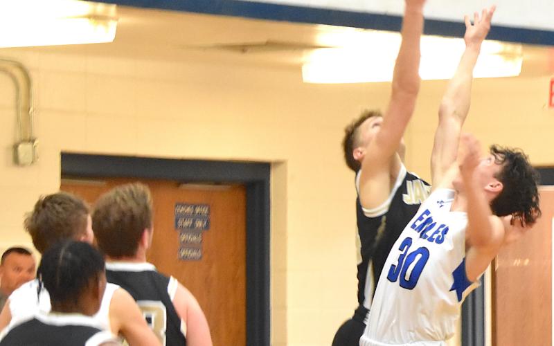Gary Corsair • Clay County Progress Hayesville's Ethan Hooper, No. 3, and Taylor McClure, No. 40, wear "Who? Me?" expressions as the referee signals a foul after a Nantahala player tumbled to the floor on a layup attempt.
