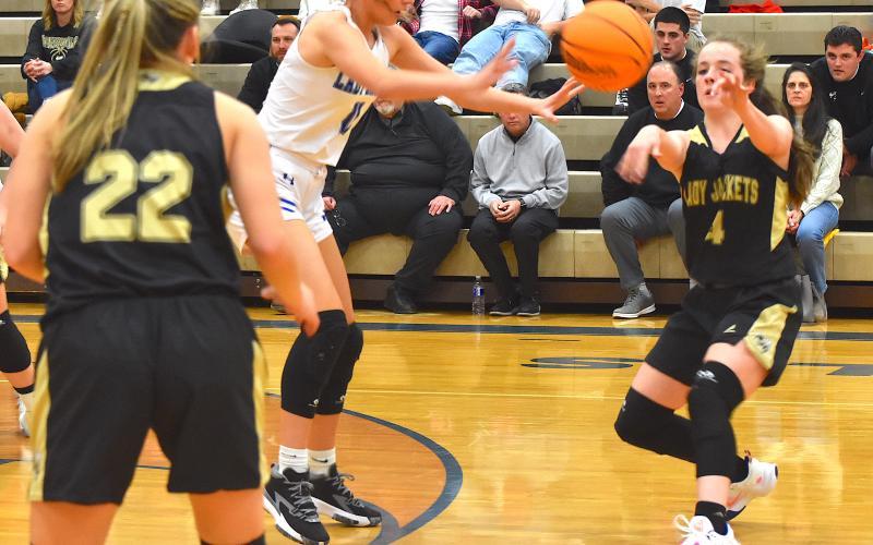 Photo by Kendra Coker Ava Moore shoots for basket scoring 20 points for the Lady Jackets against Swain.