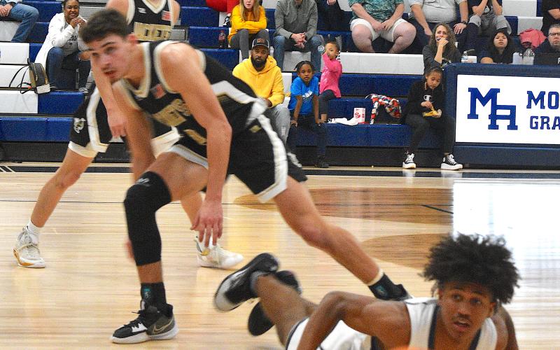Gary Corsair • Clay County Progress Logan Caldwell, No. 2, and Ethan Hooper, No. 3, watch Mario Revels unsuccessful attempt to corral the basketball.