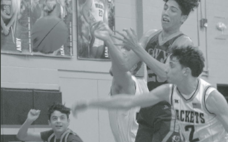 Gary Corsair • Clay County Progress Hayesville seniors Logan Caldwell, No. 2, and Kyle Lunsford, No. 33, make a Cherokee sandwich as they pursue the basketball