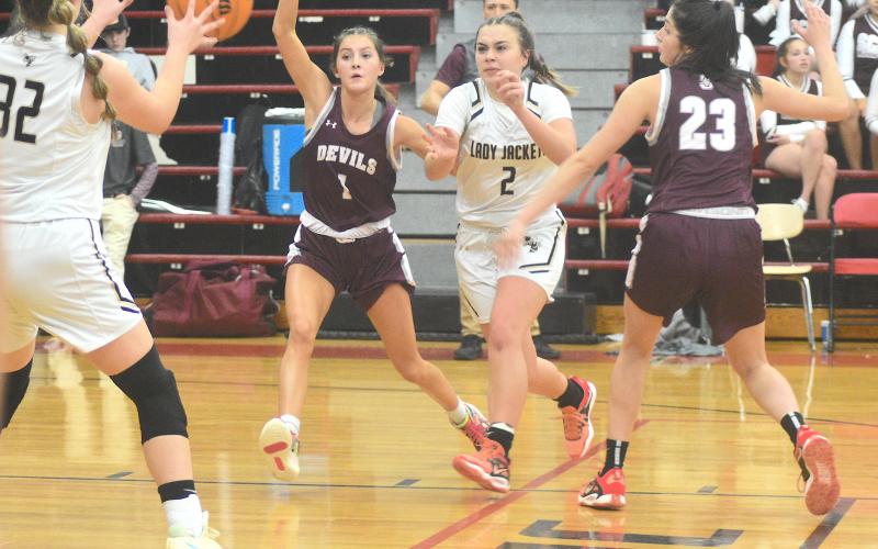 Gary Corsiar • Clay County Progress Hayesville senior Lila Roberts, No. 2, dishes to Bryleigh Krieger, No. 32, against Swain last week.