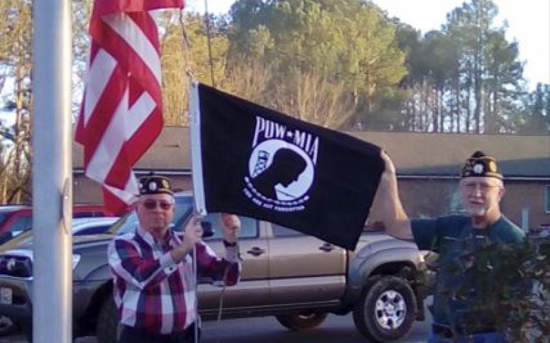 Post 532 Honor Guard member Mitchell Shields and Honor Guard Commander Dwight McClure replace the POW-MIA flag at the Clay County Care Center.