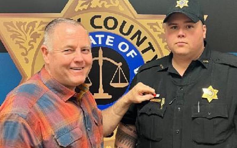 Officer Nick Queen, right, receives the Life Saving Commendation from Sheriff Mark Buchanan. Queen and Osborn  revived a man from an overdose, according to Buchanan.