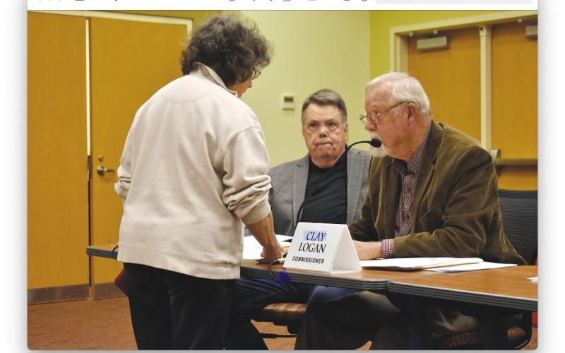 Sandy Zimmerman speaks with commissioners Scotty Penland, left, and Clay Logan prior to the March 2 meeting in the Clay County Courthouse. Zimmerman spoke during public comment recommending Town Council member Lauren Tiger for a seat on the Four Square Community Action Board of which she was appointed. Tiger will replace Logan who is coming off the board.