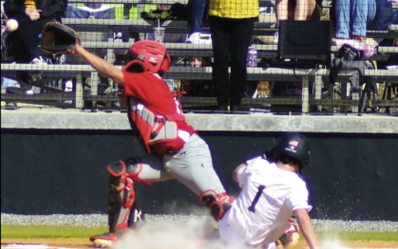 Gary Corsair • Clay County Progress Michael Mauney, No. 1, delights fans by sliding into the plate with an inside-the-park to put Hayesville up 1-0 against Andrews.