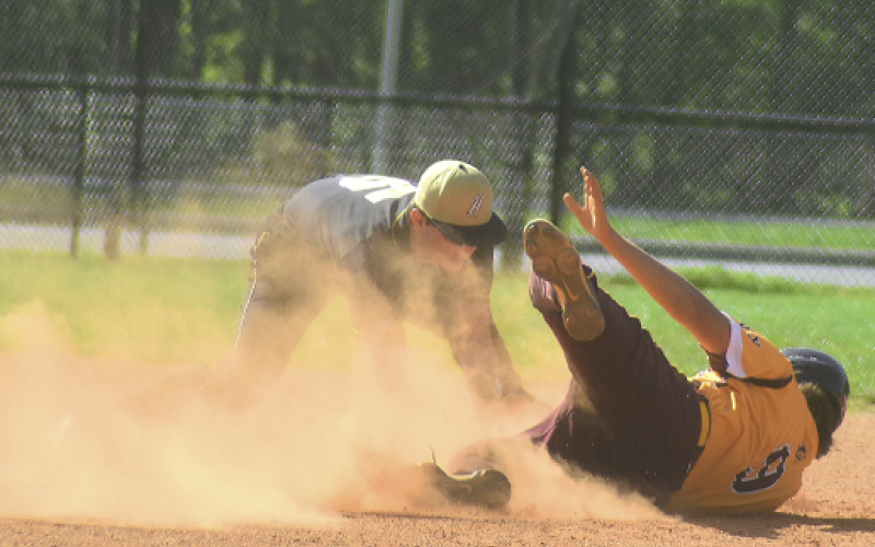 Gary Corsair • Clay County Progress Hayesville shortstop Dakota Matheson applies the tag to a Cherokee base runner on an attempted steal of second base.