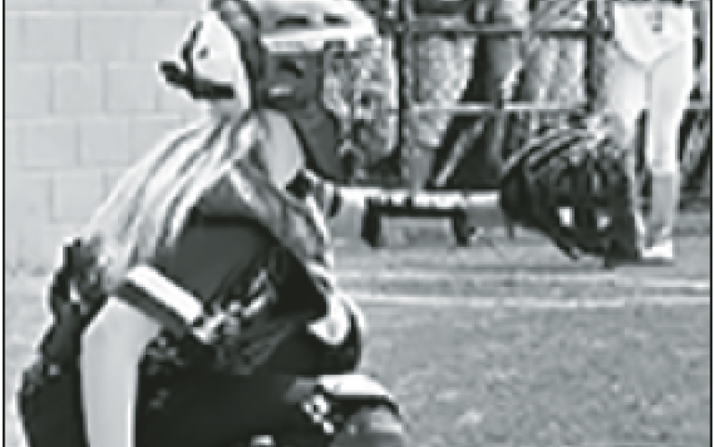 Caroline Wade is behind the plate for the HMS Lady Jackets.