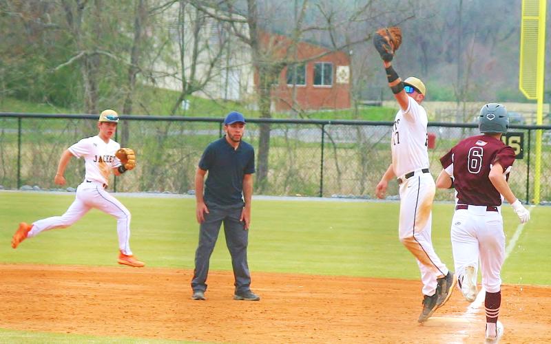 Photo by Brian Burch Hayesville first sacker Kyle Lunsford stretches to make a cutout against Swain as Michael Mauney races over to back up the play.