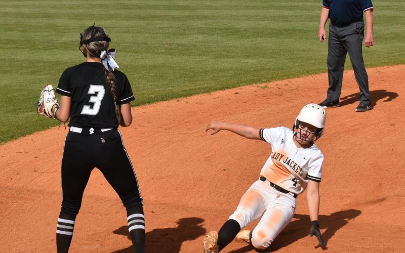 Gary Corsair • Clay County Progress Lady Yellow Jacket Faith Odell hustles into third base during a Hayesville rally against visiting Robbinsville.