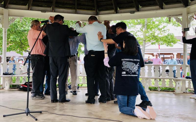 Jin Woo-Kim (right) shares prayer with local pastors, assisted by Min Sun-Park and the over 100 in attendance on the square in Hayesville during the Prayers for America gathering on Sunday. Prayer teams visited Clay County during their Prayers for America journey. During their stay here prayers were shared in Clay, Cherokee and Graham counties and the Eastern Band of Cherokee before moving on to Charlotte, N.C.