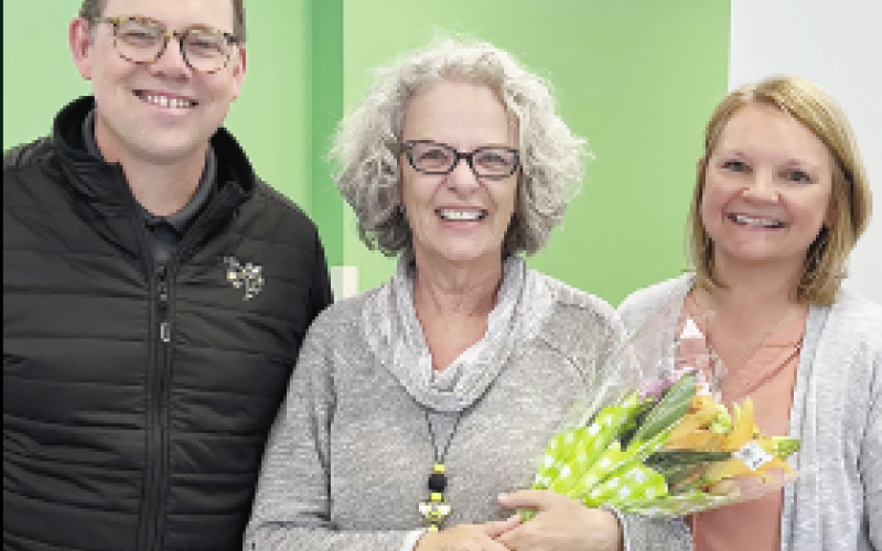 Hayesville Primary School Teacher Assistant of the Year Rosemary Russo-Wells, center, was honored with flowers by Clay Schools Superintendent Dale Cole and HPS principal Heather Plemmons.