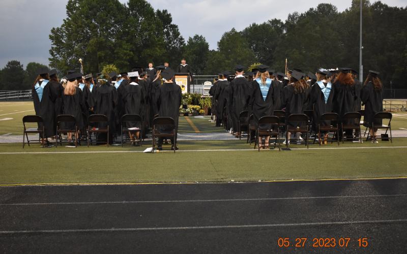HHS Principal Stacey Overlin presents the graduates to school board chairman Dr. Jason Shook.