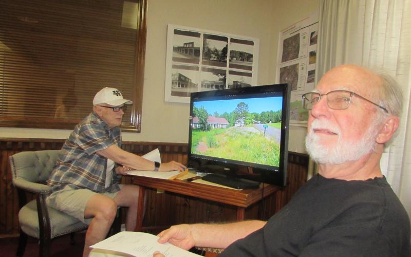 Lorraine Bennett • Clay County Progress Zoning Administrator Ron Wallace shows photos of Dogwood Lane property needing cleanup to Mayor Joe Slaton and the Town Council.
