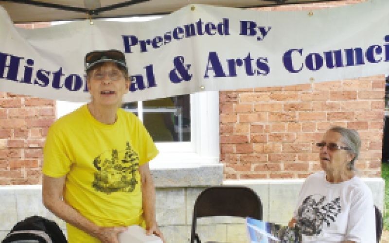 Becky Long • Clay County Progress Historical &amp; Arts Council Co-Chair Reba Beck joins Pat Stamey under their information and T-shirt tent. Proceeds from sales go to the CCHAC.