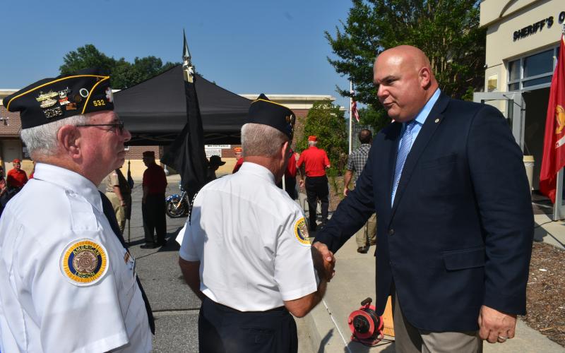 Becky Long • Clay County Progress Clay County Chief Deputy Todd Wingate shakes hands with an American Legion member after the memorial service.