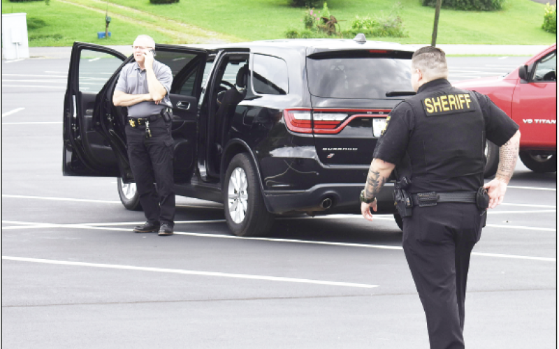 Becky Long • Clay County Progress Sheriff Mark Buchanan coordinates through his cellphone from the parking lot of First Free Will Baptist Church/Carolina Christian Academy after the pastor received a politically motivated call. No one was threatened or injured in the incident, but the sheriff’s office took precautions and manned the site while tracking down the caller.