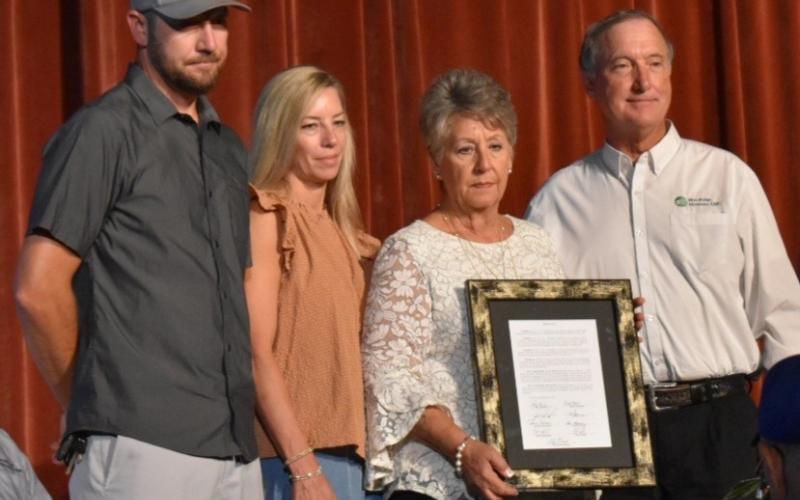 Bill Belian/Contributing Photographer  The Satterfield family accepts a framed Resolution on behalf of Roy G. "Joe" Satterfield for his years of service and dedication to Blue Ridge Mountain Electric Membership Corp. The resolution was presented by Roy Perren, president of the board of directors, right.