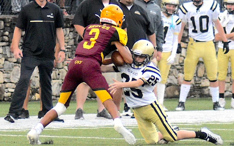Gary Corsair • Clay County Progress Hayesville's Braiden Tanner, No. 25, puts the clamps on a Cherokee ball carrier.