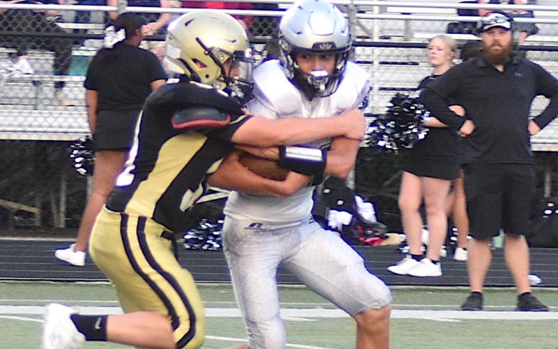 Gary Corsair • Clay County Progress Hayesville's Parker Thompson, No. 34, drops Robbinsville for a loss.