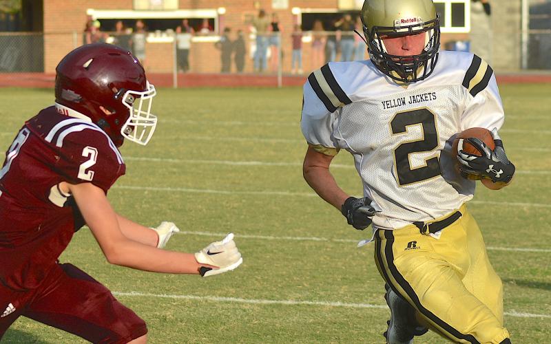Gary Corsair • Clay County Progress Yellow Jacket running back Johan Webb, No. 2, jets around the end against Swain.