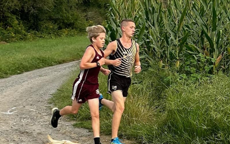 Micah Moss rounds the corner and heads to the finish line for a 6th place finish to lead the HMS boys team.