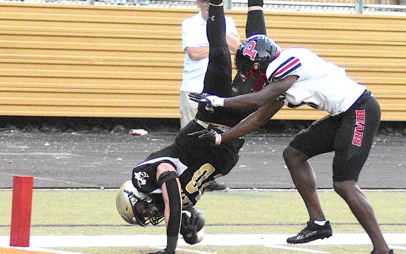 Gary Corsair • Clay County Progress Hayesville running back Taylor McClure, No. 20, finishes a 7-yard dash to the goal line by leaping for the corner of the end zone in the first quarter against Pisgah Friday.